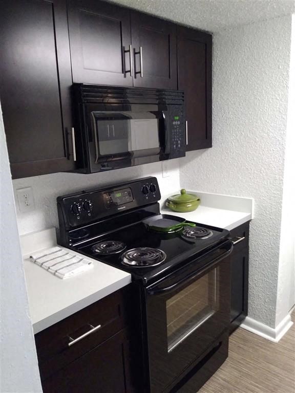 a kitchen with a stove and a microwave