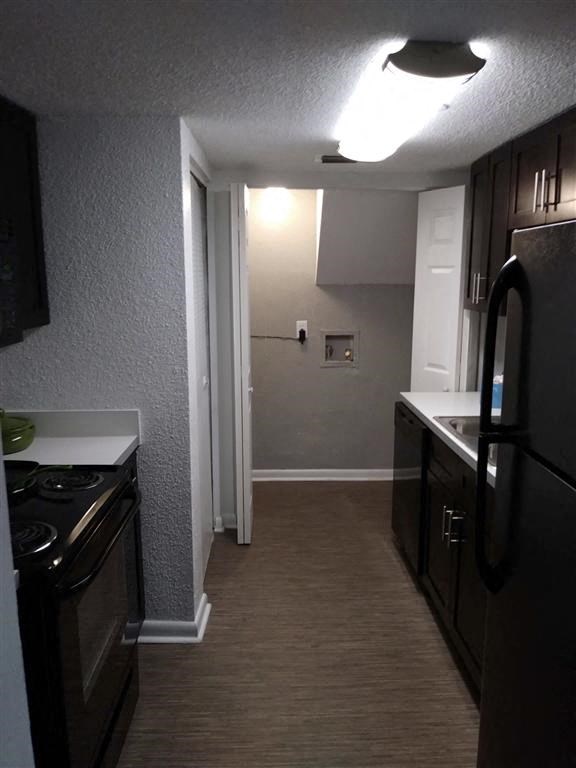 a kitchen with a stove and a sink and a refrigerator