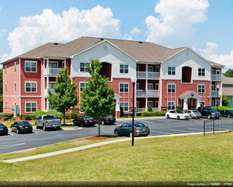 Haven at Reed Creek Parking lot with grenery at the Haven at Reed Creek apartments Martinez, GA