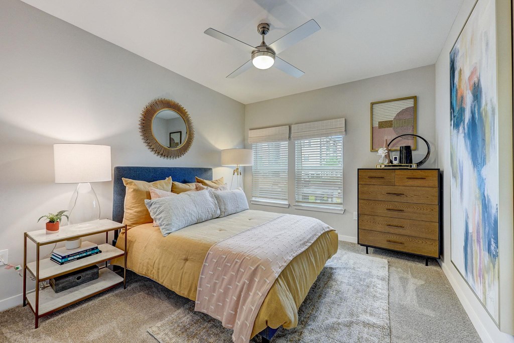 a bedroom with a bed and a ceiling fan at Century Mundy Mill Apartments, Oakwood, GA