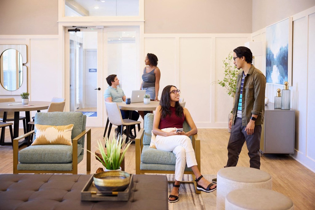 a group of people standing and sitting in a living room at Century Mundy Mill Apartments, Oakwood 30566