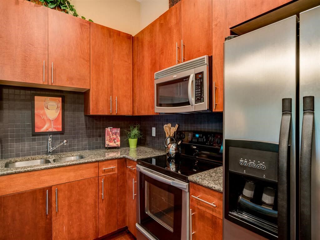 a kitchen with stainless steel appliances and wooden cabinets