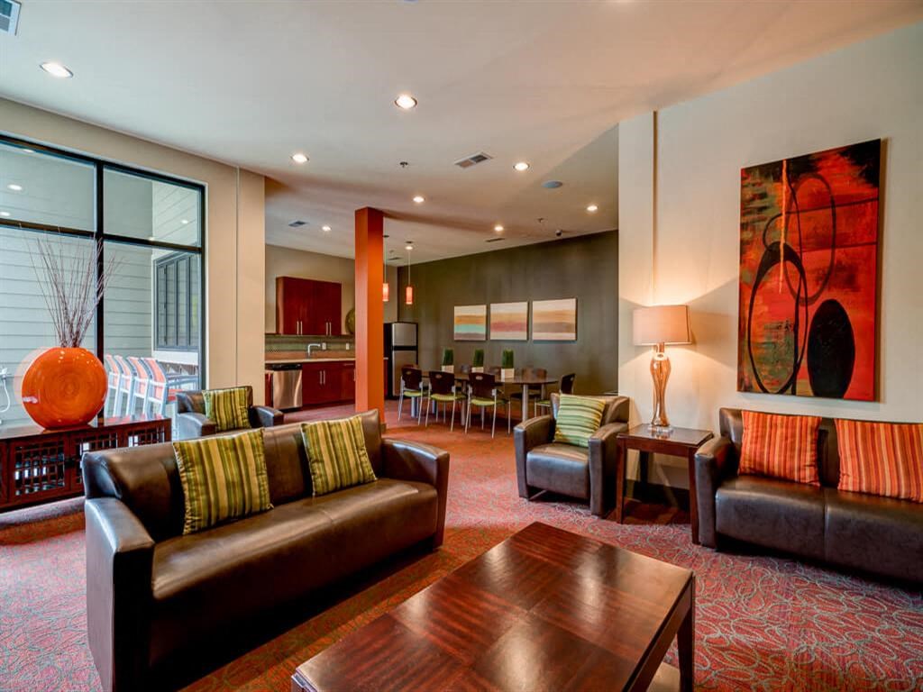 a living room with couches and chairs and a table