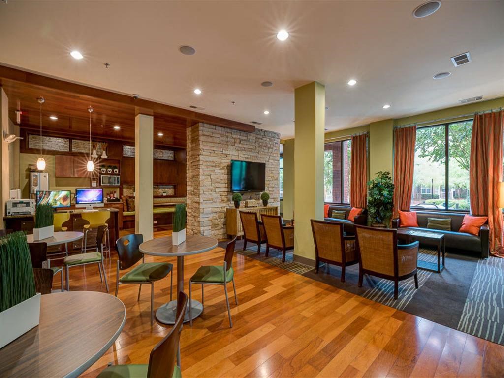 a living room with tables and chairs and a television