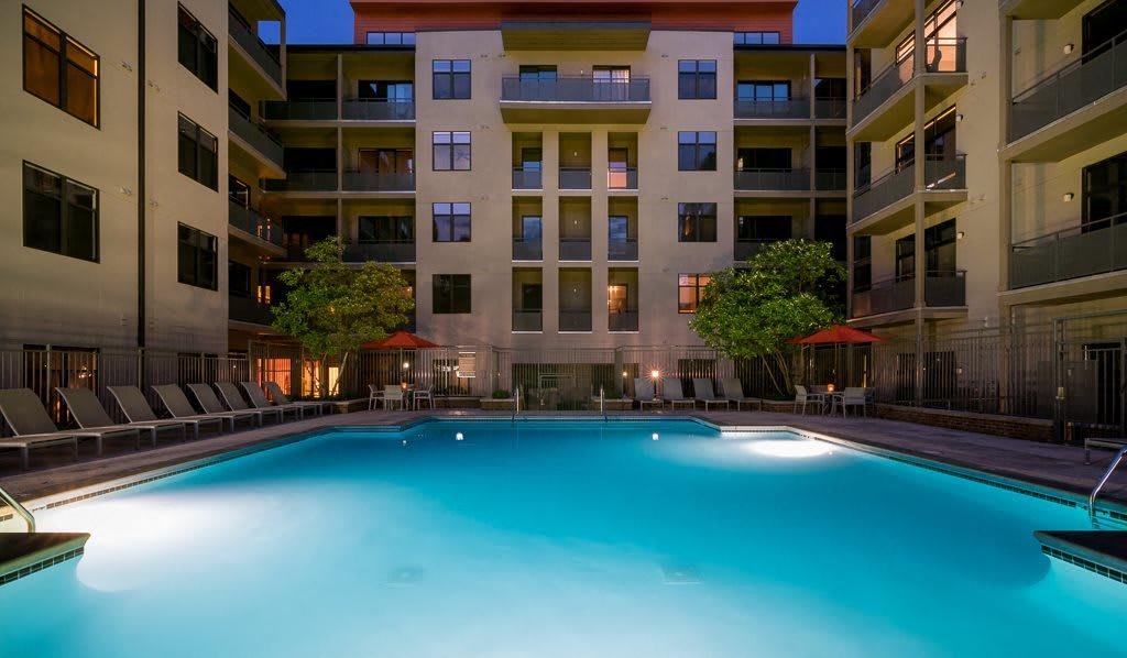 a swimming pool in front of an apartment building