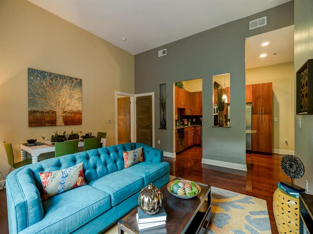 a living room with a blue couch and a table