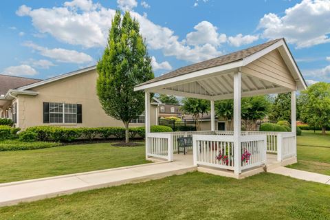 a white gazebo in front of a house