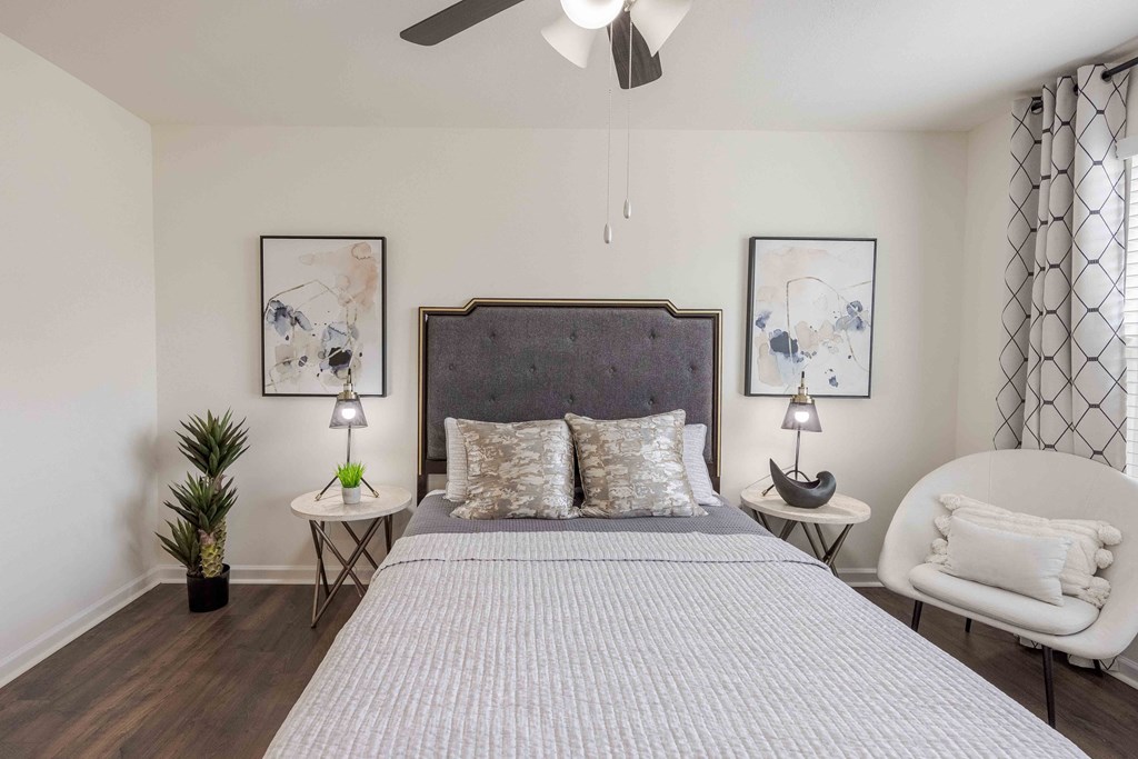 a bedroom with a bed and a ceiling fan