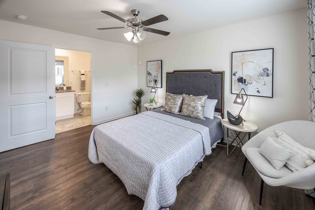 a bedroom with a bed and a ceiling fan