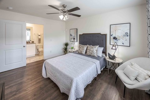 a bedroom with a bed and a ceiling fan