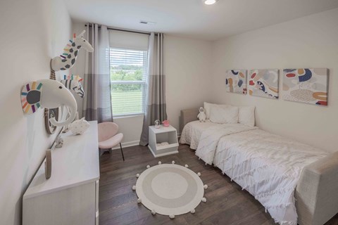 a bedroom with a bed and a desk and a window