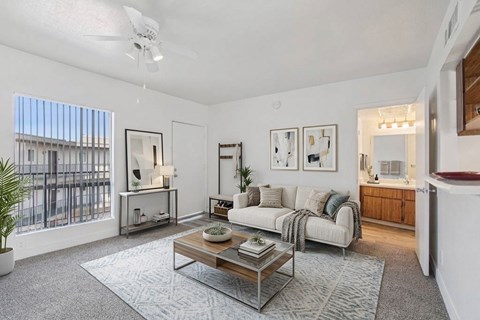 A living room with a white couch and a coffee table.