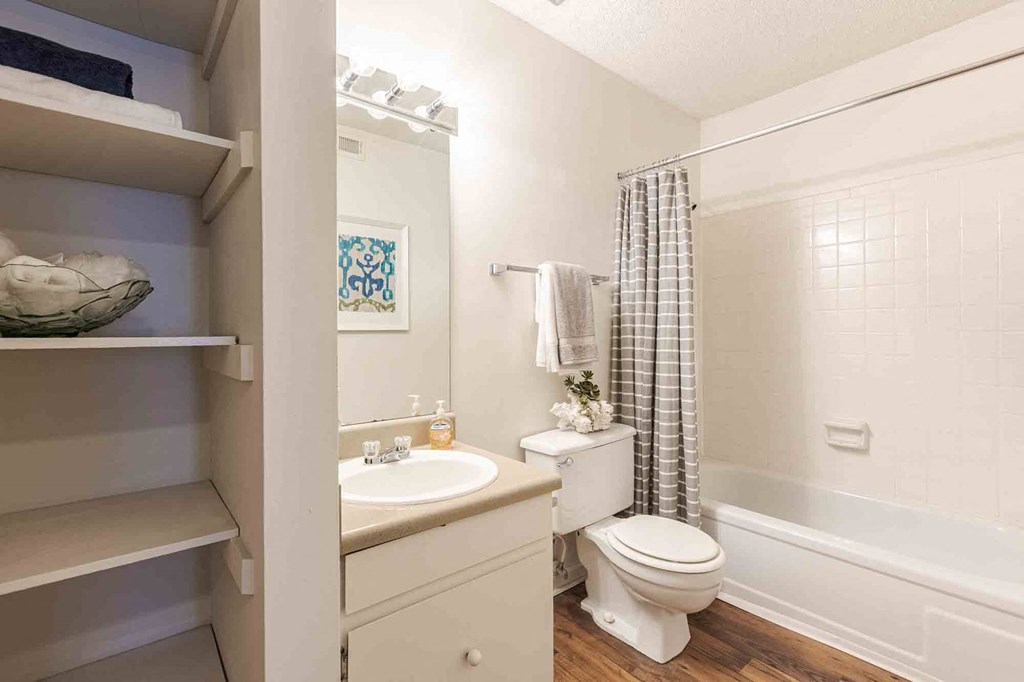A white bathroom with a toilet, sink, and shower. at Grove at St. Andrews, Columbia, SC, 29210