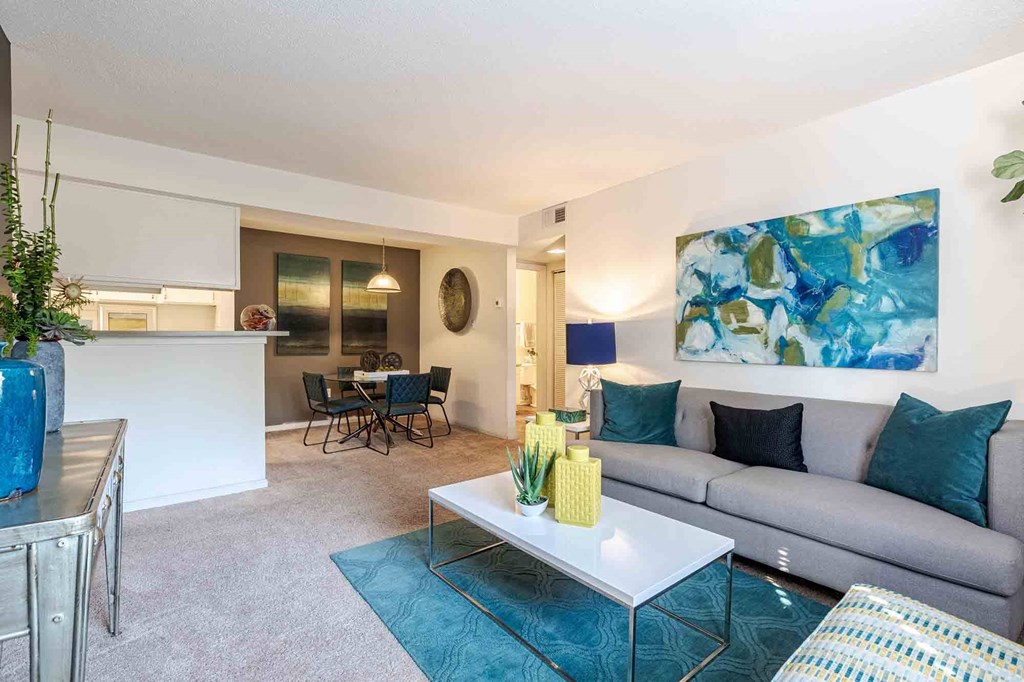 A living room with a grey couch, a white coffee table, and a blue rug. at Grove at St. Andrews, Columbia