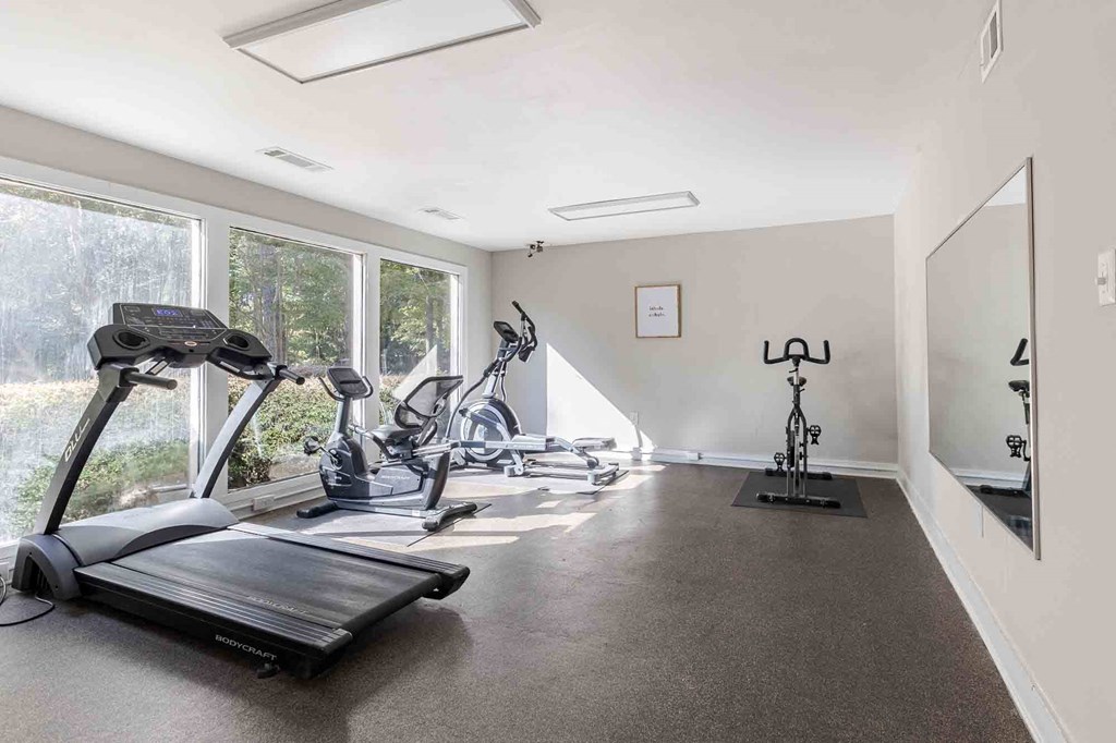 A spacious room with exercise equipment and a large window. at Grove at St. Andrews, Columbia, SC