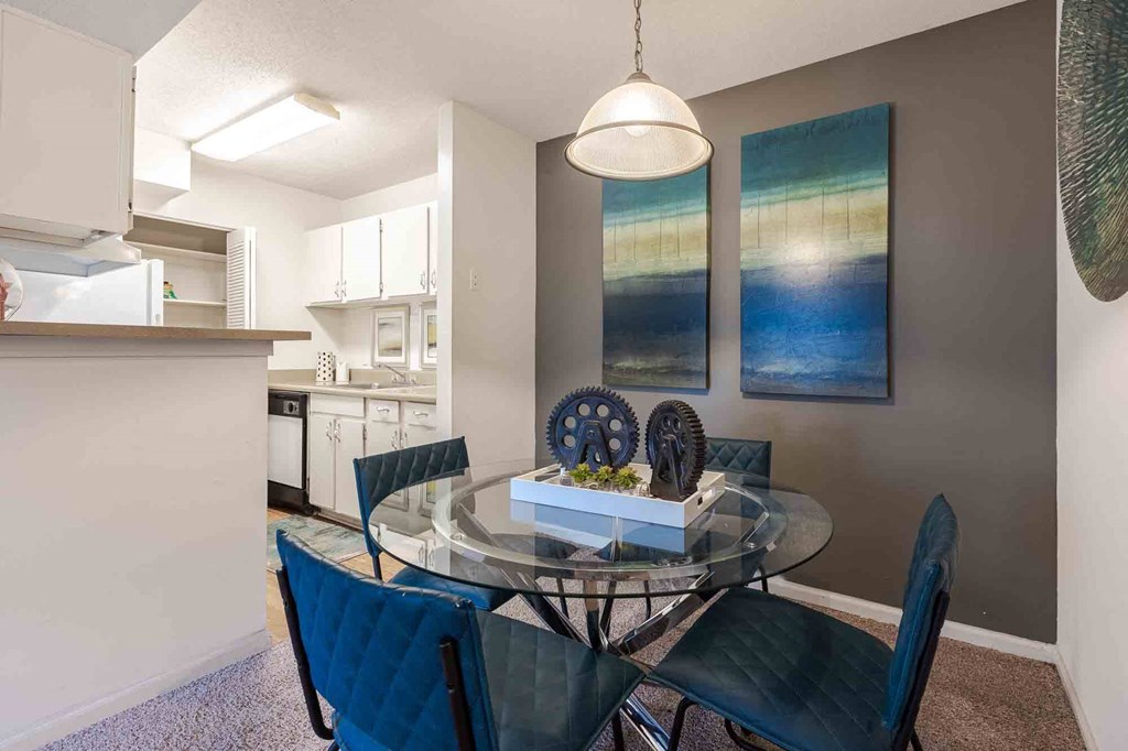 A dining room with a glass table and chairs. at Grove at St. Andrews, Columbia, South Carolina