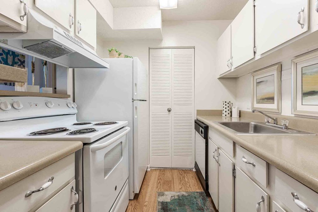 A kitchen with white appliances and cabinets. at Grove at St. Andrews, Columbia, SC, 29210