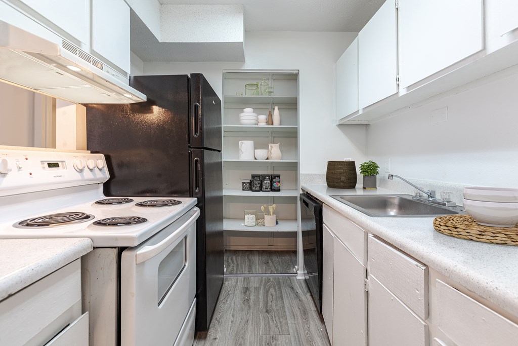 A modern kitchen with white appliances and a black refrigerator. at Grove at St. Andrews, Columbia, 29210