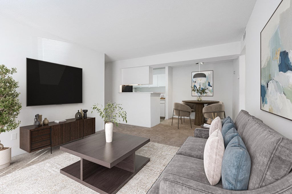 A modern living room with a grey couch and a wooden coffee table. at Grove at St. Andrews, South Carolina