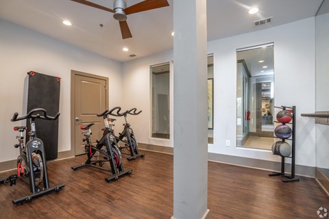 A room with a wood floor and a ceiling fan.
