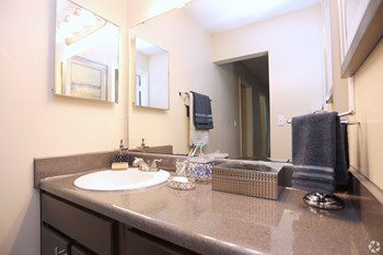 bathroom with large mirror and medicine cabinet at Harvard Place Apartments, Lithonia, GA, 30058 - Photo Gallery 34
