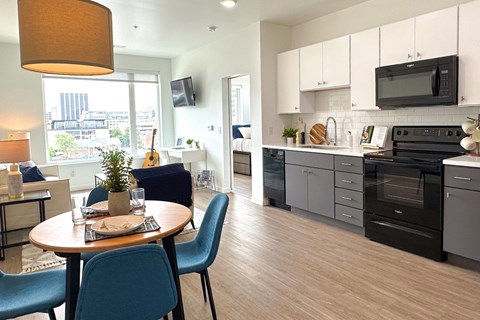 A modern kitchen with a dining table and chairs.
