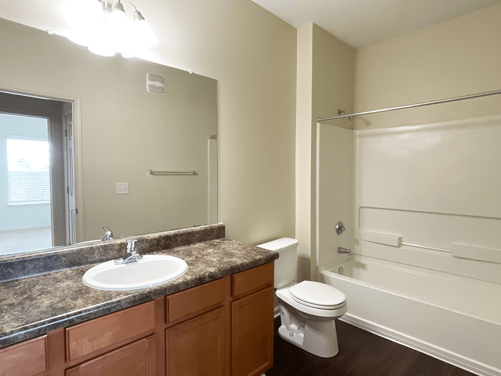 an empty bathroom with a sink toilet and shower