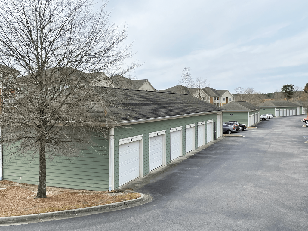 a row of garages on the side of a street