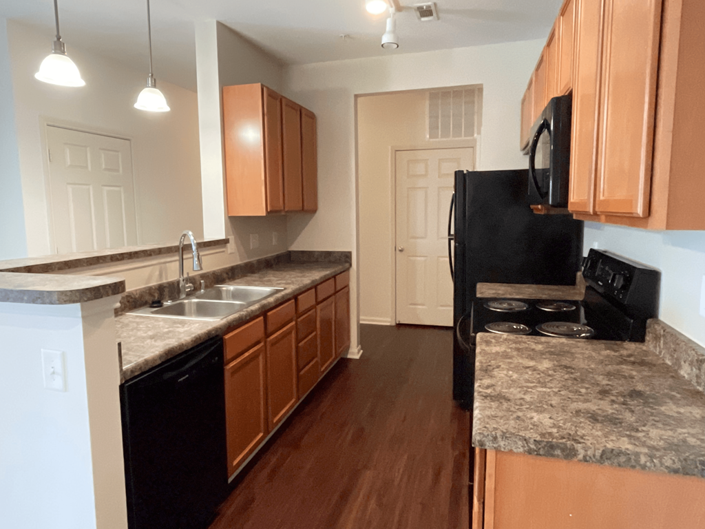 a kitchen with wooden cabinets and granite counter tops