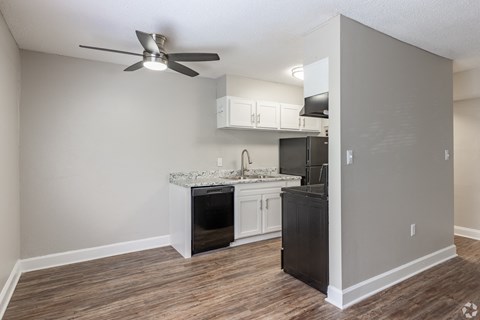 a kitchen and living room with a ceiling fan at Summit Augusta, Augusta, 30909