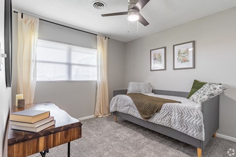 a bedroom with a bed and a ceiling fan at Summit Augusta, Augusta Georgia