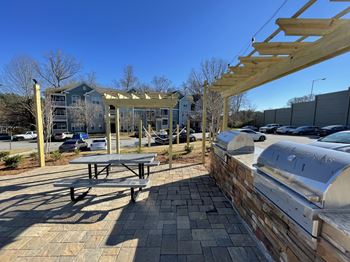 2 grills with countertop and a bench at Edgewater Vista, Decatur, GA