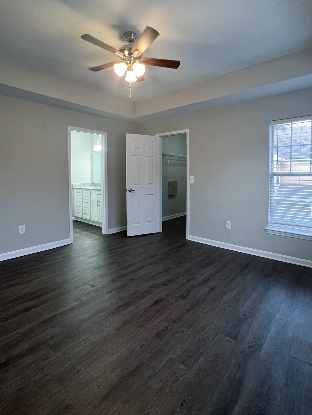 Open floor plan with ceiling fan and large windows Dakota Mill Creek Buford, GA