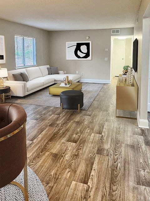 a living room with a wooden floor and a couch and a table