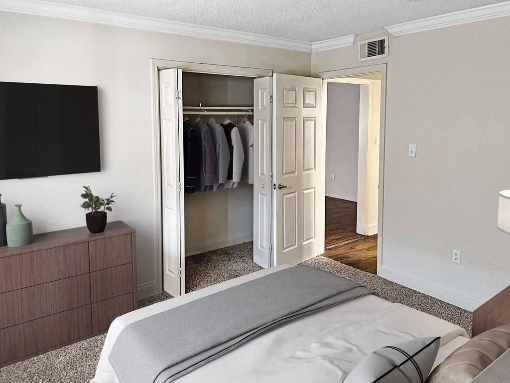 a bedroom with a bed and a closet with a door open