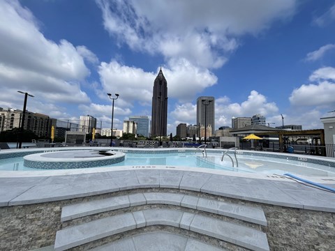 a pool with a city skyline in the background