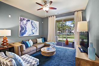 Living Room With Private Balcony at Century Crosstown Apartments, Tampa, Florida