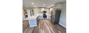 A kitchen with a white counter top and stainless steel appliances at Briarcliff at Quechee, Quechee, 5059