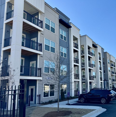 an apartment building with a car parked in front of it