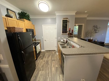 Edgewater Vista Apartments, Decatur Georgia, model kitchen with black appliances - Photo Gallery 10