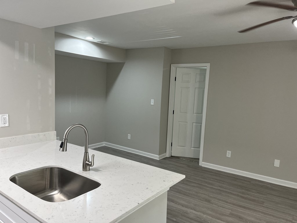 a kitchen with a sink and a ceiling fan at The Hub at 934 Apartments, Georgia, 30349