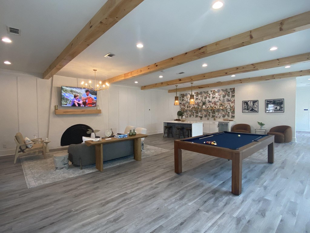 a games room with a pool table and a flat screen tv at Crescent Place Apartments, Savannah, GA, 31419