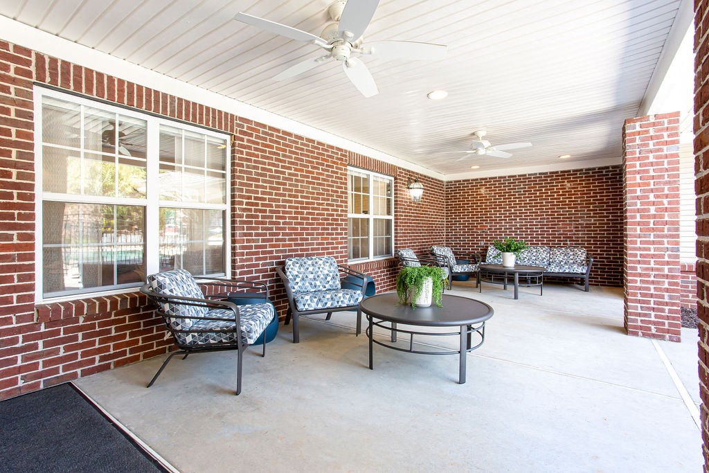 the preserve at ballantyne commons covered patio with chairs and a table at Indigo Apartments Gainesville, Gainesville Georgia