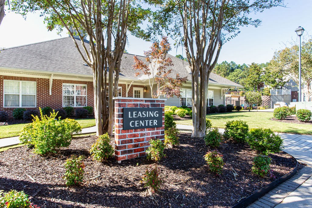 a leasing center sign in front of a house at Indigo Apartments Gainesville, Gainesville, GA 30504