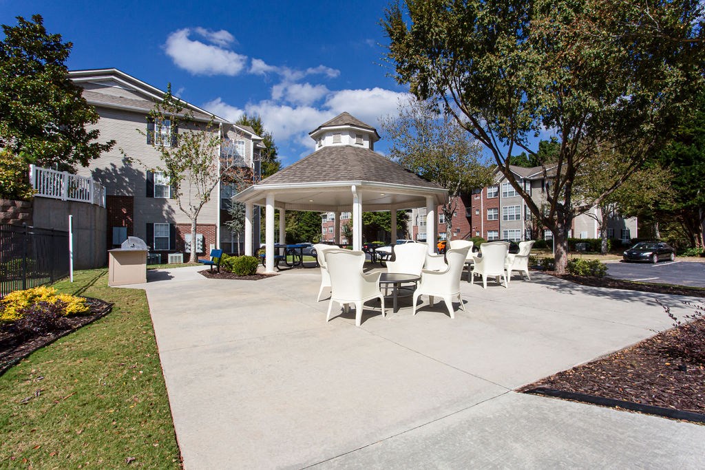 a gazebo with a table and chairs in a courtyard at Emery Village, Georgia, 30504