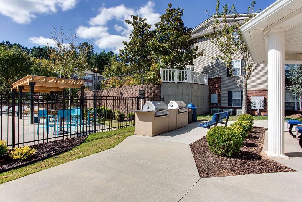 a patio with a table and chairs in front of a house at Indigo Apartments Gainesville, Georgia