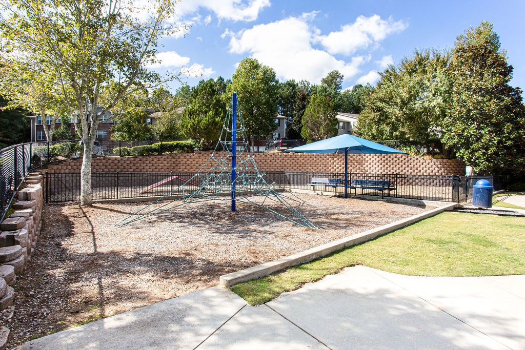 a park with a playground and a fence a park with a playground and a fence at Indigo Apartments Gainesville, Gainesville, 30504