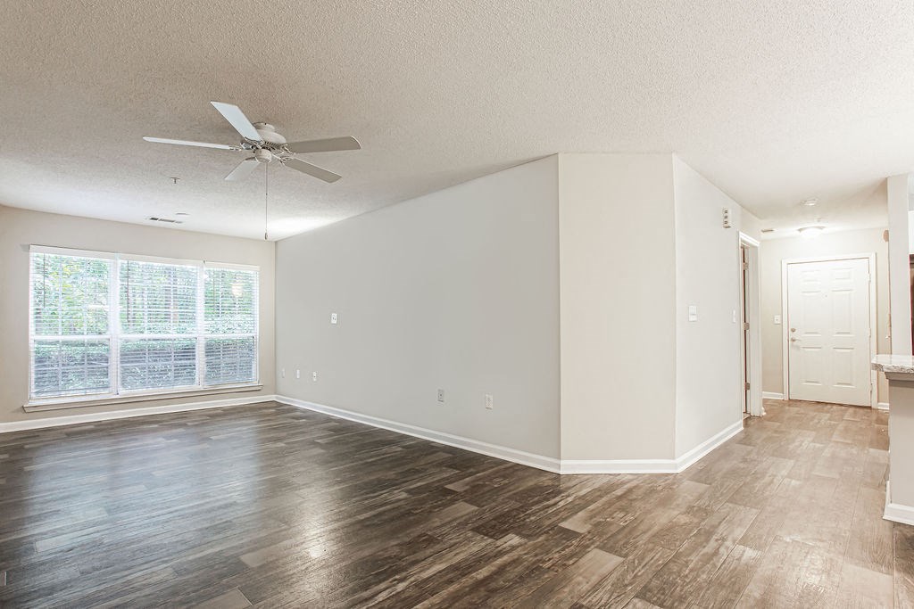 an empty living room with a ceiling fan and a window at Indigo Apartments Gainesville, Gainesville, 30504