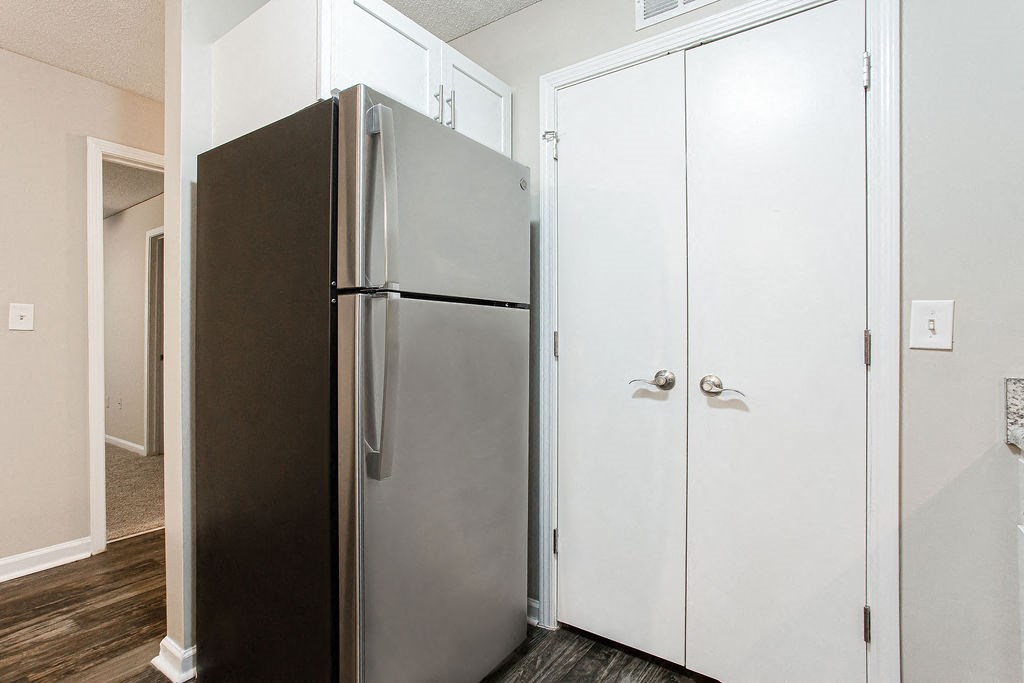 a kitchen with a refrigerator and white cabinets at Emery Village, Georgia, 30504