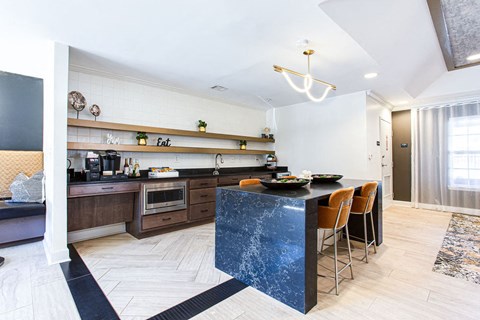 a kitchen with a blue counter top and a table with chairs